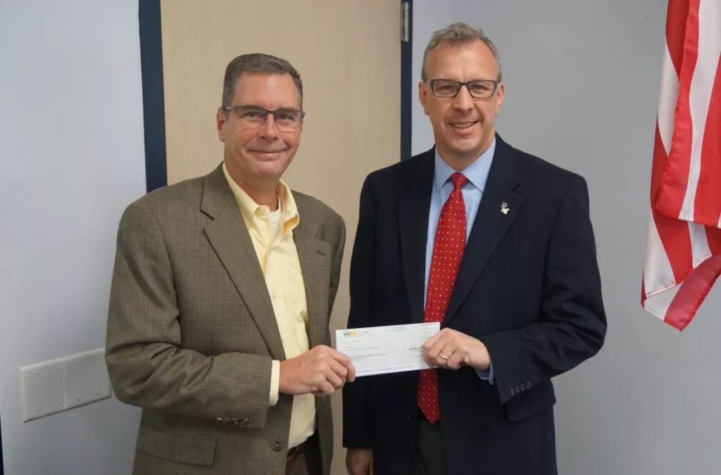 Brian Furman of Waste Management, left, presents a check to Mike Leichliter, Penn Manor superintendent.
