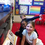 Evan, Lailani, and Mackenzie read a big book