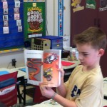 JJ reading a cool book from home