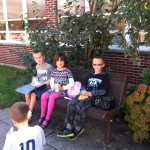 Gavin, Madelyn, Brett on the bench in the shade!